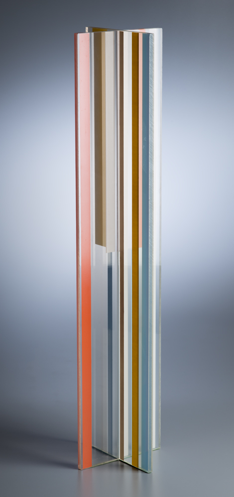 A multiple published by Reiss-Cohen. Two flat pieces of plexiglas form a cross. Strips of orange, blue, yellow and white run vertically.