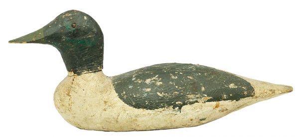 Painted wood duck decoy in dark green with white belly, chest and tail, and light green bill.