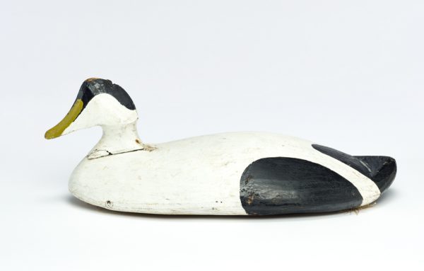 Painted wood decoy with white body, black at tail and on creast of head and a green bill.