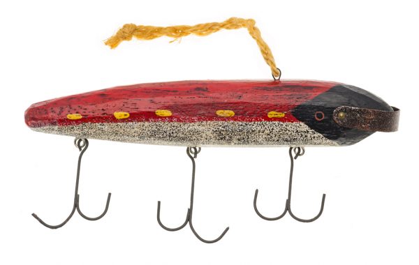 A fishing lure with a red back, speckled white and grey belly, black head. There are three hooks.