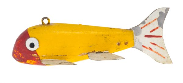 A yellow fishing lure with a red face, white metal fins and tail.