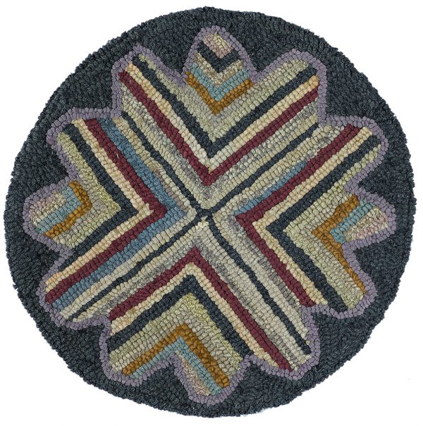 Hooked rug in a round shape with dark border. Design is four part 