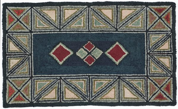 Hooked rug, center is dark blue with two red diamonds on either side of a diamond divided into four smaller diamonds. The border is of triangles in red, gray and peach color.