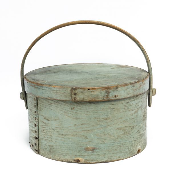 A round box with lid and bent wood handle in blue-gray.