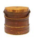 Round wood box with lid and bent wood handle in brown. Cover has almost no paint. Rather straight sided. Double lap around bottom.