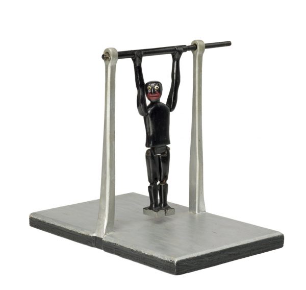A toy of an acrobat who can turn flips over the top bar.