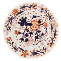 Plate in blue, orange and gold on cream.