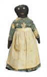 A female bottle doll has a green flowered dress and a white cotton apron. She has button eyes, embroidered mouth.