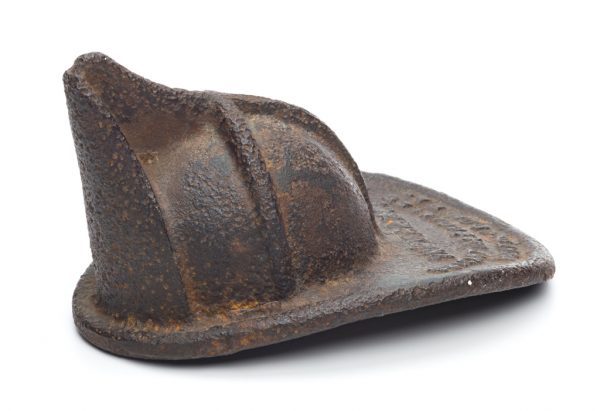 A paper weight in the shape of a fireman's hat.