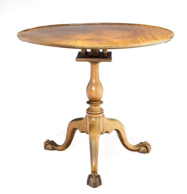 Mahogany bird cage tilt top table on turned support, with ball and claw feet.