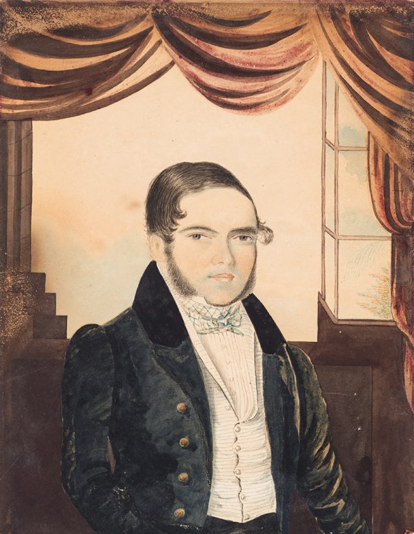 The man wears a black suit, white vest and shirt. A curtain is above.