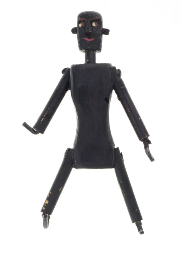 A small figurine of a man made from a carved wood block, dowels, aluminum rod, nails, glue, and paint. The hands and feet are all made from bent aluminum rod.