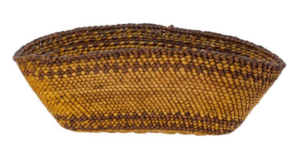 Salish oval  basket. Small twinned plant fiber basket with wide mouth and tapered sides. Wrapped fibers are undyed with
two rows of darker brown, one below the rim and one above the base. The rim is also darker brown.