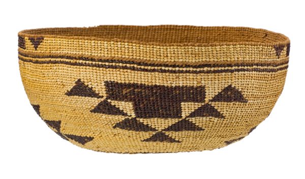 Round basket with black on natural background. Top edge is stripes and middle has triangualr designs. The bottom has a star or flower motif.