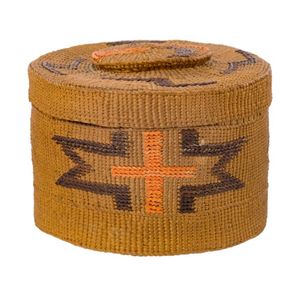 A woven basket with rattle top lid. The motifs are in black and orange-diamonds, zig-zag and cross shapes, on natural color.