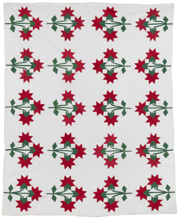 Tri-Flowers in red and green on white background. Handpieced and quilted with cotton fill