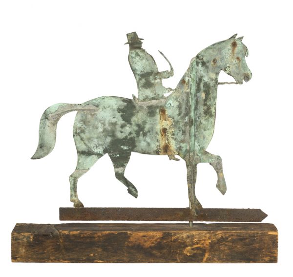 A weather vane depicting a horse with male rider holding a short sword or quirt. The weathervane is made of cut sheet metal.