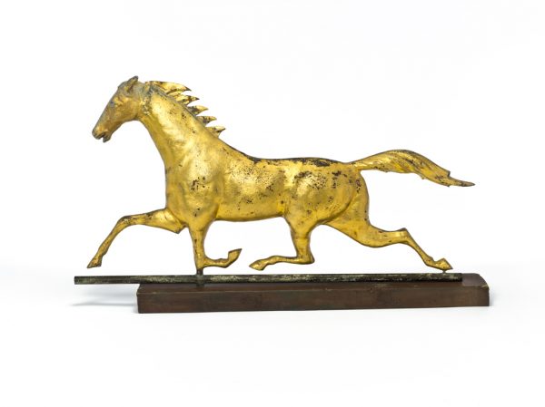 A weathervane depicting a running horse.