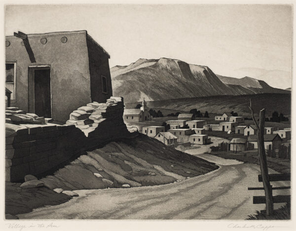 An adobe village with a road running from bottom center toward the center of the image. At left is a partial view of an adobe building with stone fence. Near the center, in the distance is a church. Mountains are in the background.