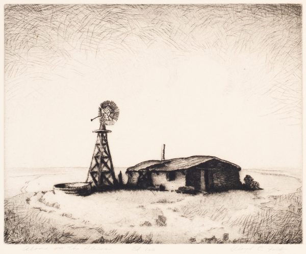 A low house on the prairie, has a windmill and water trough, to the left of the house