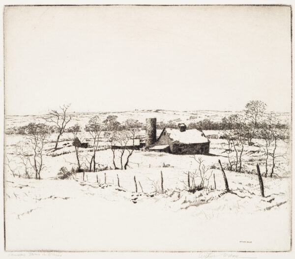 A view of a farm consisting of several buildings and a silo. There is a barbed wire and wood post fence in the foreground with a few small leafless trees scattered throughout.