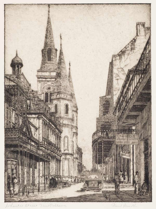 A city street with early automobiles, pedestrians and buildings with towers.