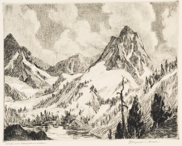 Snow covered mountains with sharp peaks, against a cloudy sky. There are a few fir trees in the bottom corners.