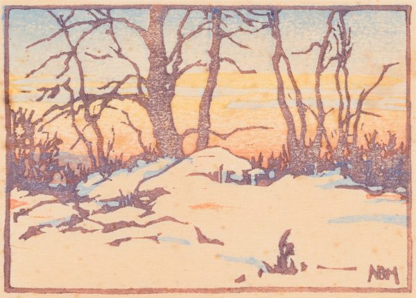 A snowy landscape featuring a copse of barren trees agains a sunset.