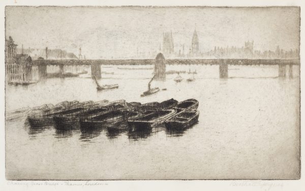 A bridge and cityscape, with a line of fishing boats floating in the foreground.