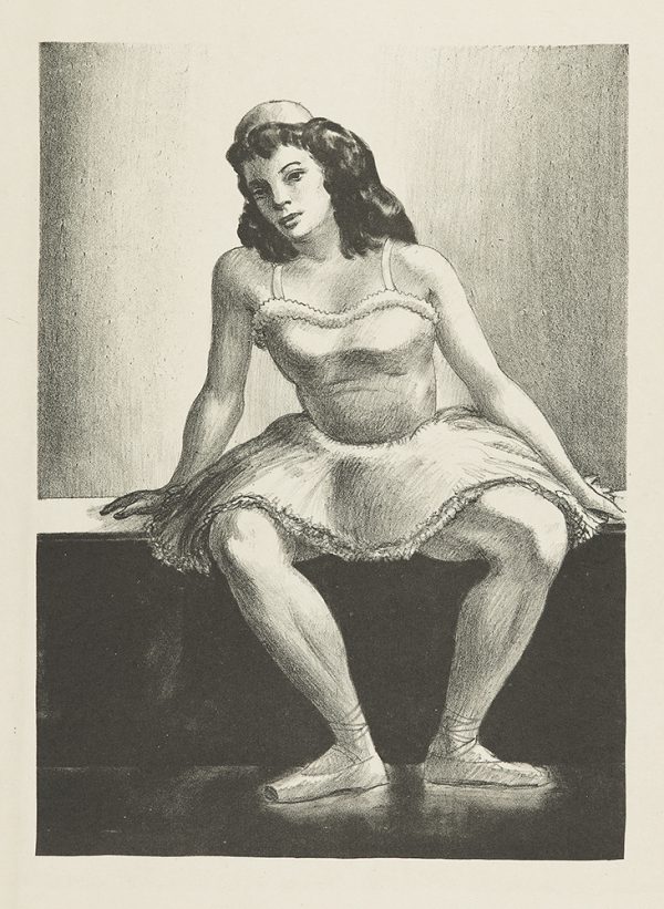A young girl, wearing a short ballerina gown, sits with feet turned out.