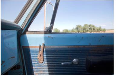 Vise-grips replace the original window crank to a truck door.
