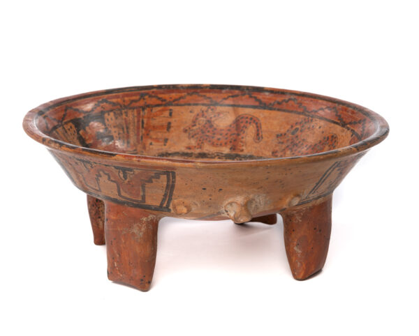 This bowl is a rattle. There are four legs, The ground is a light terra cotta color with black and dark terra cotta for decoration. the design is in three friezes on the interior. The middle frieze includes two young jaguars, and one head with feather headdress, repeated twice. The center motif is too faded to describe. The exterior has geometric motifs and one small head of an animal (bat?)