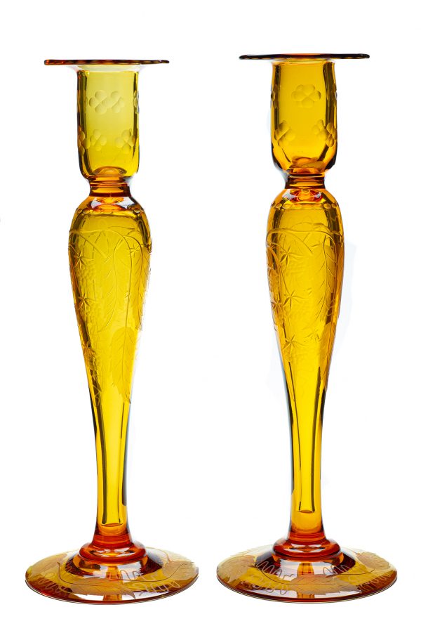 A pair of amber candlesticks in the blackberry pattern