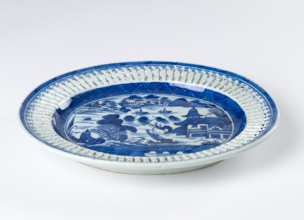 Underplate for a fruit/chestnut basket in the Blue Willow pattern with reticulated rim.