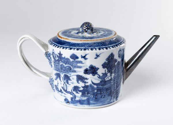 Covered Teapot with double strap handles, berry knob on a cover which may be too small to be original. The pot and cover have a slightly fluted shape. There are traced of gilding on the handle and on the knob