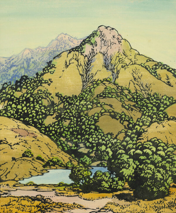 Landscape with trees and lake in the foreground and mountains in the background