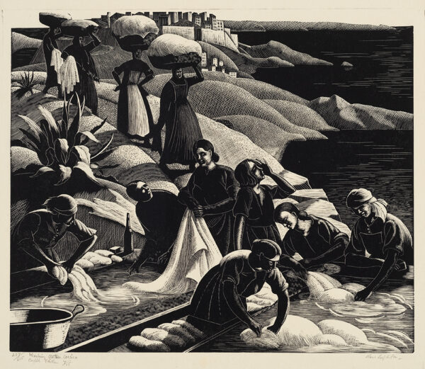 A group of women are washing white linens in a river. More women are arriving with the white linens wrapped in a bundle balanced on their heads.
