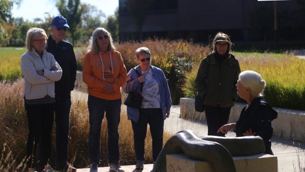 Exterior view of the Art Garden with a group of adults taking a tour with a WAM docent