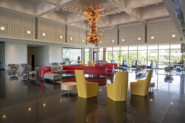Interior view of the Great Hall with color chairs and tables and the Chihuly Chandelier hanging from the ceiling
