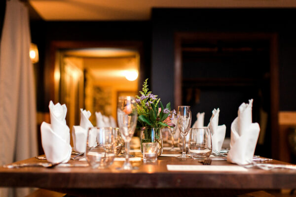 Table setting from Elderslie Farm with multiple glasses, plates, white napkins and silverware