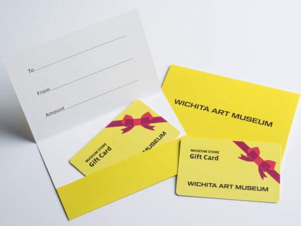 Photo of yellow gift cards with red ribbon on them and a paper holder