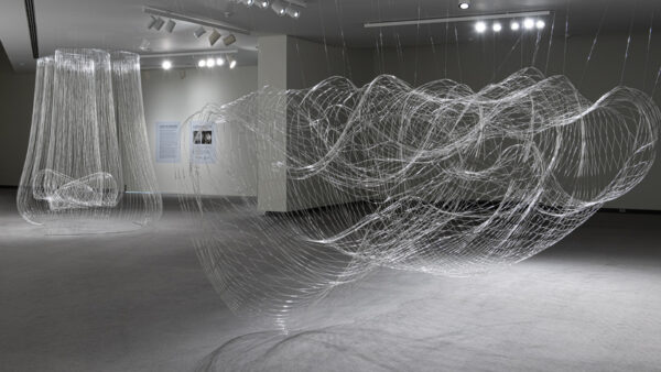 Gallery photo of beaded wire suspended from the ceiling in circular patterns.