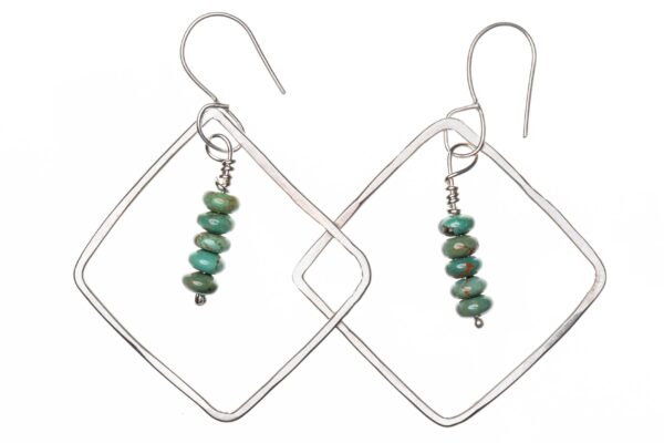 Silver diamond-shaped dangle earrings with four turquoise beads suspended on wire in the middle. Earrings are suspended on French hooks for pierced ears.