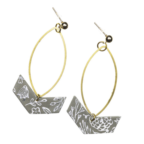 Gold post-style earrings with an oval-shaped rings with a gray and white floral pattern arrow shaped dangle.