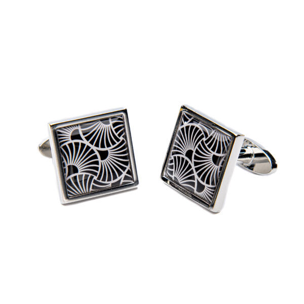 Cufflinks in solver with an enamel front with a black and white, art deco-inspired geometric pattern