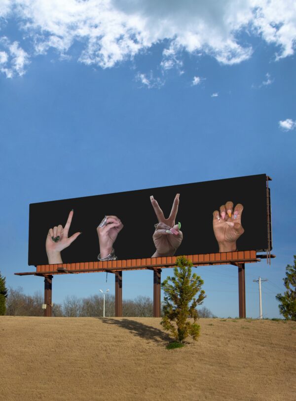 Billboard with hands showing the word Love in sign language